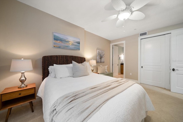 202 Windward Psge Unit 304, Clearwater Beach, FL 33767 - bedroom with light colored carpet, a closet, and a ceiling fan