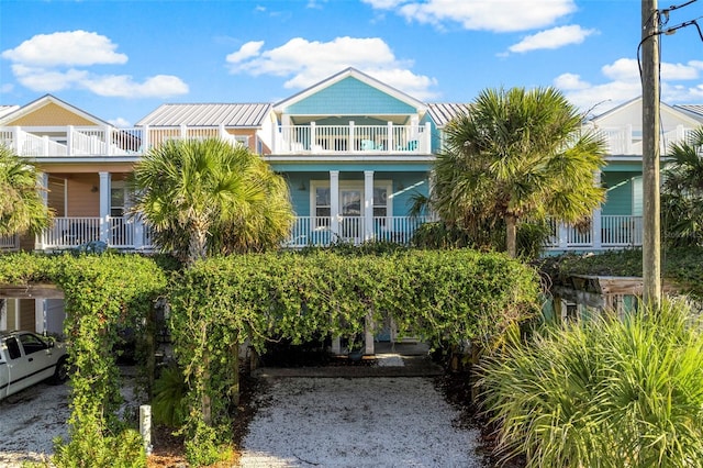 view of front of property featuring a porch and a balcony