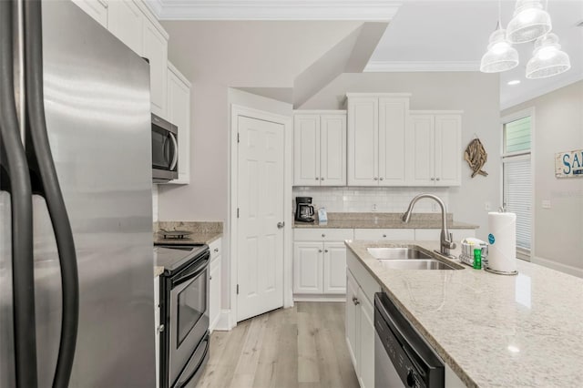 kitchen with a sink, white cabinetry, and stainless steel appliances