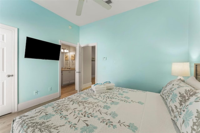 bedroom featuring ceiling fan, connected bathroom, light wood-style flooring, and baseboards