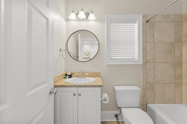 bathroom featuring vanity, toilet, and  shower combination