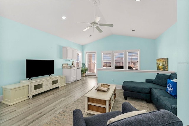 living area featuring light wood-style floors, a ceiling fan, vaulted ceiling, and recessed lighting