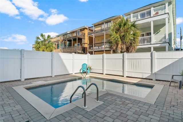view of swimming pool with a patio, a fenced backyard, and a fenced in pool