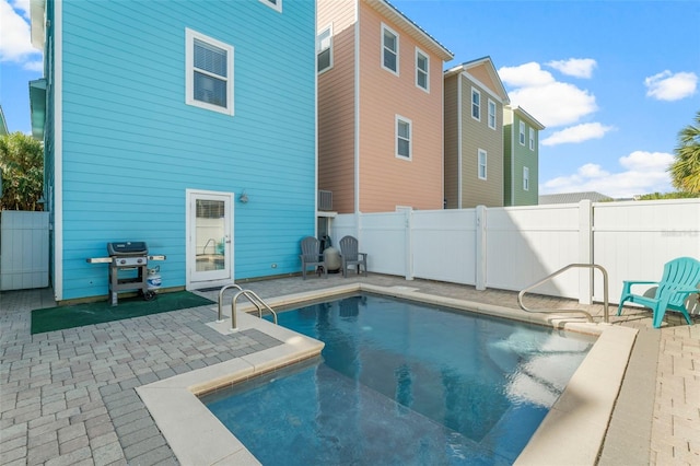 view of pool with a patio, fence, area for grilling, and a fenced in pool