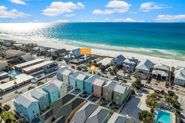 bird's eye view featuring a beach view, a water view, and a residential view