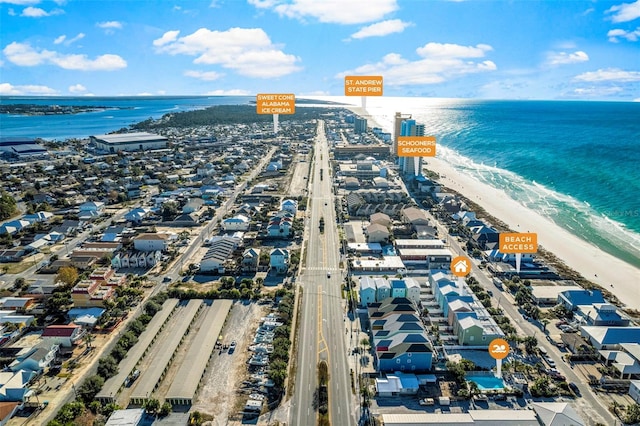 drone / aerial view featuring a beach view and a water view
