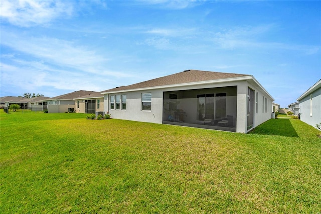 3504 Golden Wheat Ln, Plant City, FL 33565 - rear view of property featuring a yard, stucco siding, and a sunroom