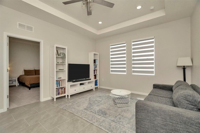 3504 Golden Wheat Ln, Plant City, FL 33565 - living room featuring a ceiling fan, baseboards, recessed lighting, a tray ceiling, and tile patterned flooring