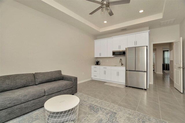3504 Golden Wheat Ln, Plant City, FL 33565 - living area with a tray ceiling, recessed lighting, baseboards, a ceiling fan, and light tile patterned flooring