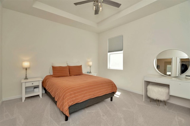 3504 Golden Wheat Ln, Plant City, FL 33565 - bedroom featuring light colored carpet, baseboards, a tray ceiling, and a ceiling fan