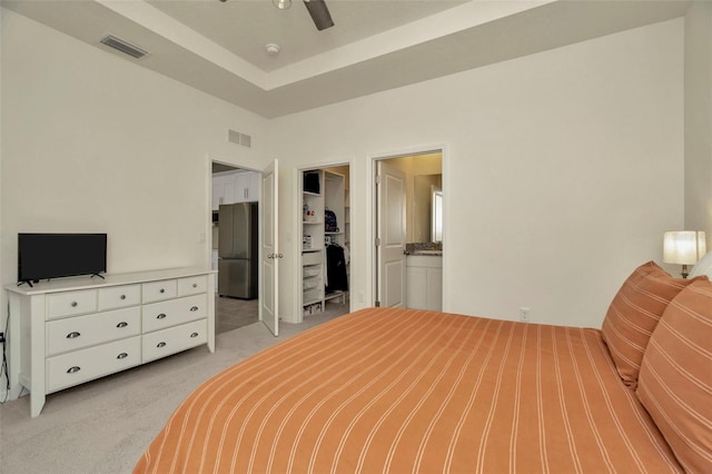 3504 Golden Wheat Ln, Plant City, FL 33565 - bedroom featuring freestanding refrigerator, light colored carpet, a spacious closet, a closet, and ensuite bathroom