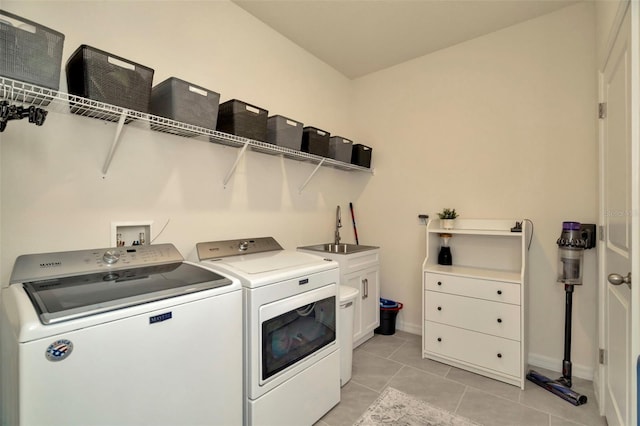 3504 Golden Wheat Ln, Plant City, FL 33565 - washroom featuring washing machine and dryer, a sink, baseboards, and light tile patterned floors