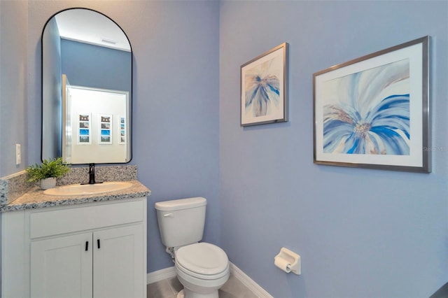3504 Golden Wheat Ln, Plant City, FL 33565 - bathroom featuring toilet, vanity, and baseboards