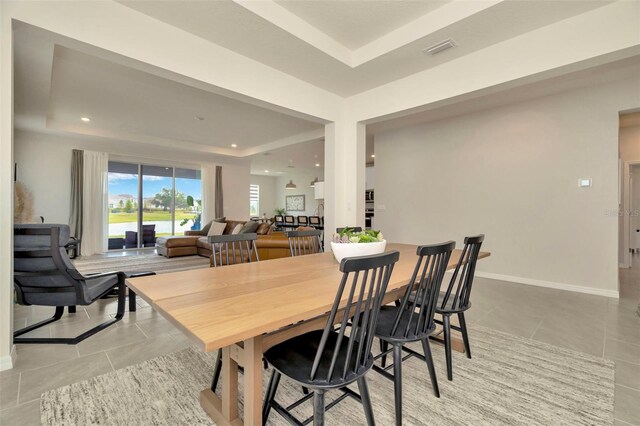 3504 Golden Wheat Ln, Plant City, FL 33565 - dining area featuring a raised ceiling, light tile patterned floors, baseboards, and recessed lighting