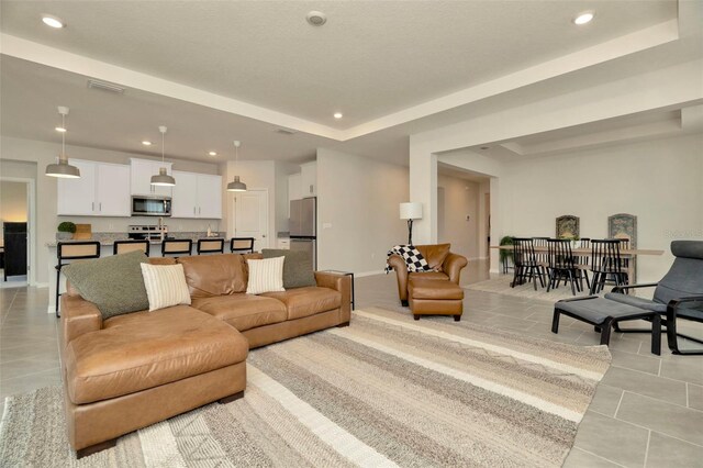 3504 Golden Wheat Ln, Plant City, FL 33565 - living area with light tile patterned floors, a raised ceiling, recessed lighting, and baseboards