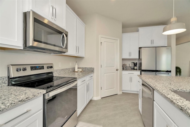 3504 Golden Wheat Ln, Plant City, FL 33565 - kitchen with stainless steel appliances, white cabinets, light tile patterned floors, and decorative light fixtures