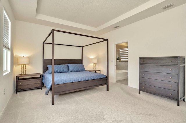 3504 Golden Wheat Ln, Plant City, FL 33565 - bedroom with carpet flooring, baseboards, a raised ceiling, and connected bathroom