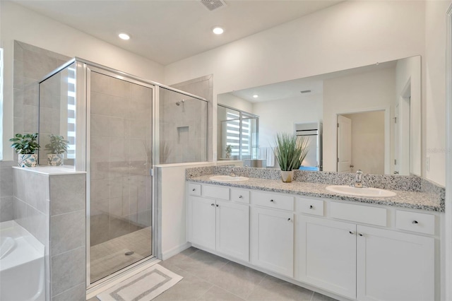 3504 Golden Wheat Ln, Plant City, FL 33565 - full bath featuring a shower stall, double vanity, a garden tub, tile patterned floors, and recessed lighting