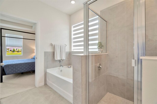 3504 Golden Wheat Ln, Plant City, FL 33565 - bathroom featuring a bath, ensuite bath, a stall shower, and tile patterned floors