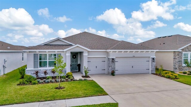 3504 Golden Wheat Ln, Plant City, FL 33565 - single story home with stone siding, a garage, concrete driveway, a front yard, and stucco siding