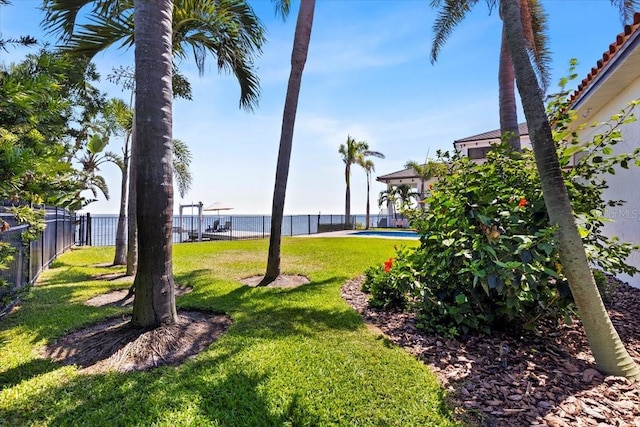view of yard with a fenced in pool and fence