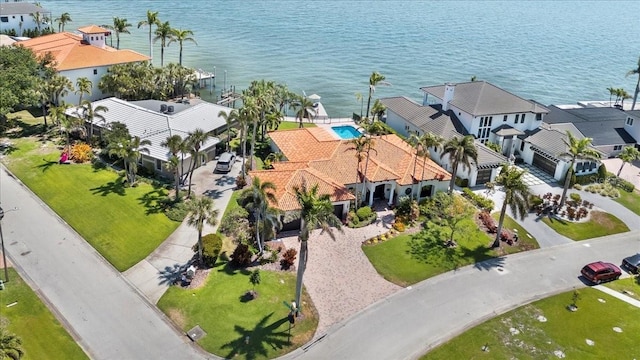 drone / aerial view featuring a residential view and a water view