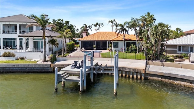 view of dock with a patio, boat lift, and a water view