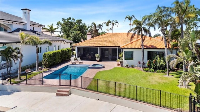 view of pool with a fenced backyard, a sunroom, and a yard