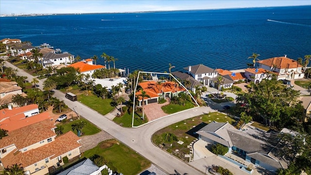bird's eye view featuring a residential view and a water view