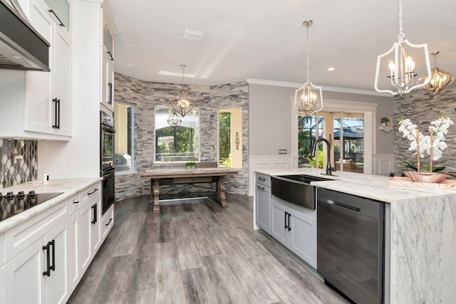 kitchen featuring a sink, under cabinet range hood, black appliances, an inviting chandelier, and wood finished floors
