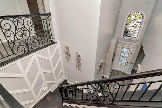 stairs featuring a towering ceiling