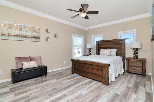 bedroom with baseboards, light wood finished floors, multiple windows, and crown molding