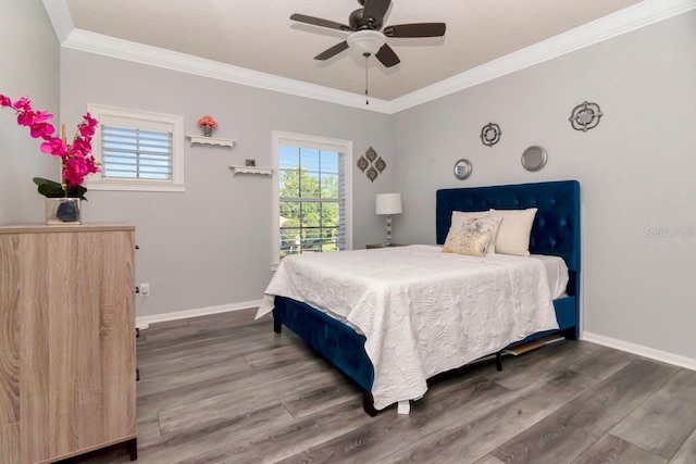 bedroom featuring ornamental molding, wood finished floors, and baseboards