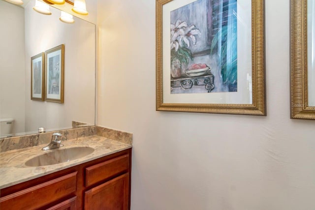 half bathroom with toilet and vanity