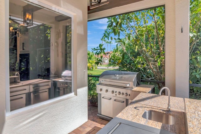 view of patio with a sink and exterior kitchen