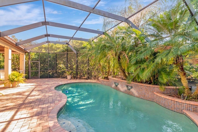 outdoor pool with a patio and glass enclosure