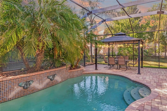 outdoor pool featuring fence, a gazebo, glass enclosure, and a patio area