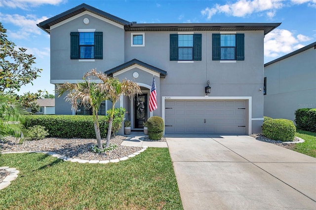 traditional-style home with concrete driveway, stucco siding, and a garage