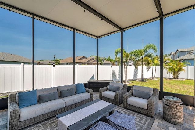 sunroom / solarium featuring a residential view and an outdoor living space