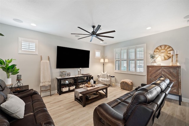 living area featuring a ceiling fan, a healthy amount of sunlight, light wood-style floors, and recessed lighting
