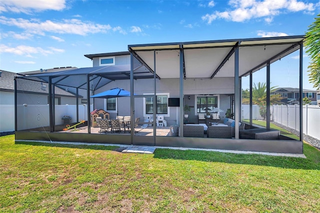 rear view of house with a fenced backyard, stucco siding, a patio, an outdoor living space, and a lawn