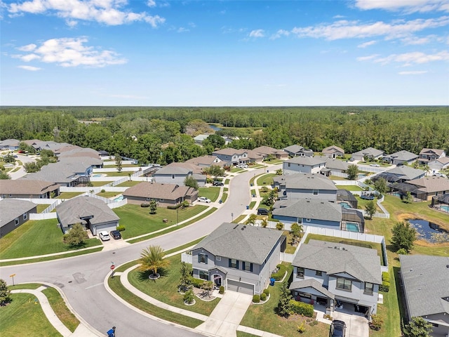 birds eye view of property featuring a residential view and a wooded view