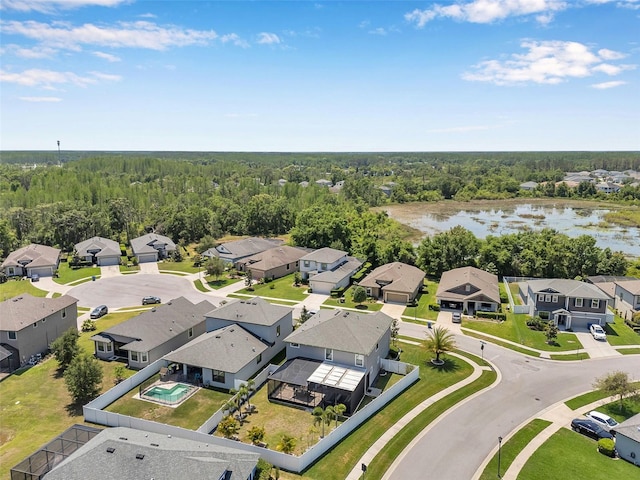 aerial view featuring a forest view, a water view, and a residential view