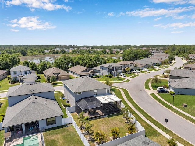 drone / aerial view featuring a residential view and a water view