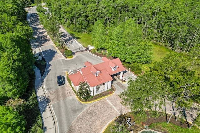 drone / aerial view with a wooded view