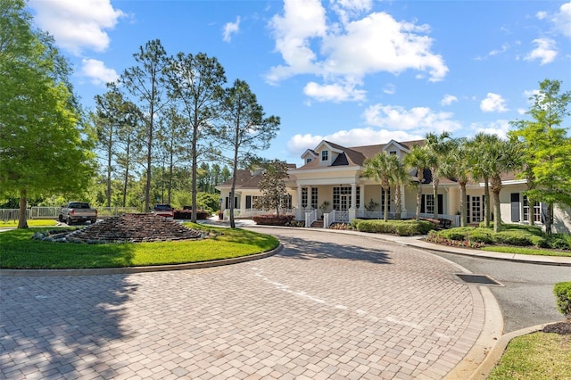 view of front facade with a porch and curved driveway