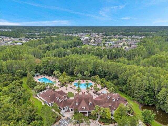 drone / aerial view featuring a wooded view