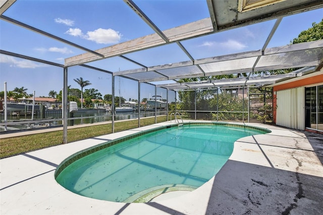 outdoor pool with a patio, a water view, a lanai, and a yard