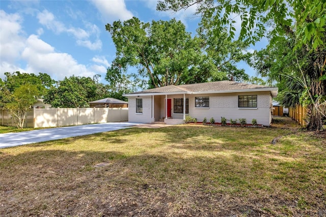 single story home featuring fence, a front lawn, and brick siding