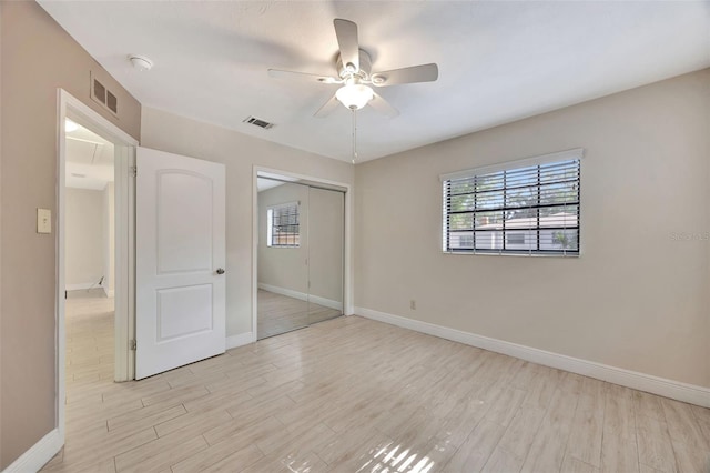 unfurnished bedroom featuring baseboards, visible vents, and light wood-style flooring